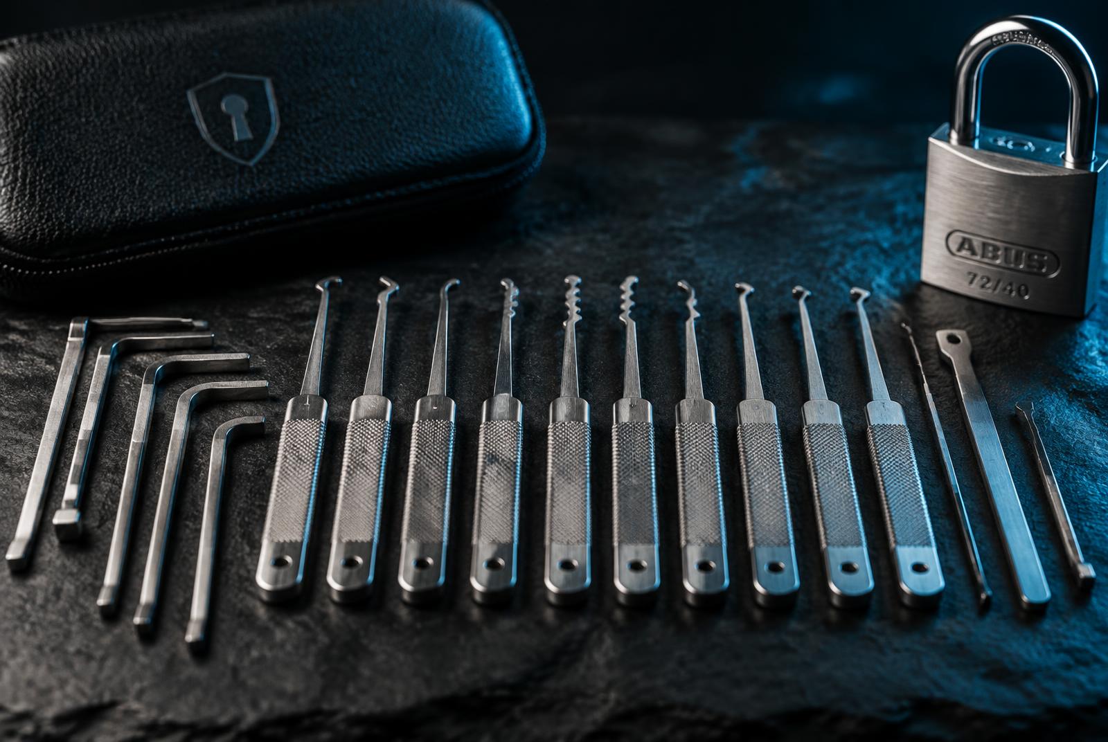 Set of lock picks laid out on a dark surface